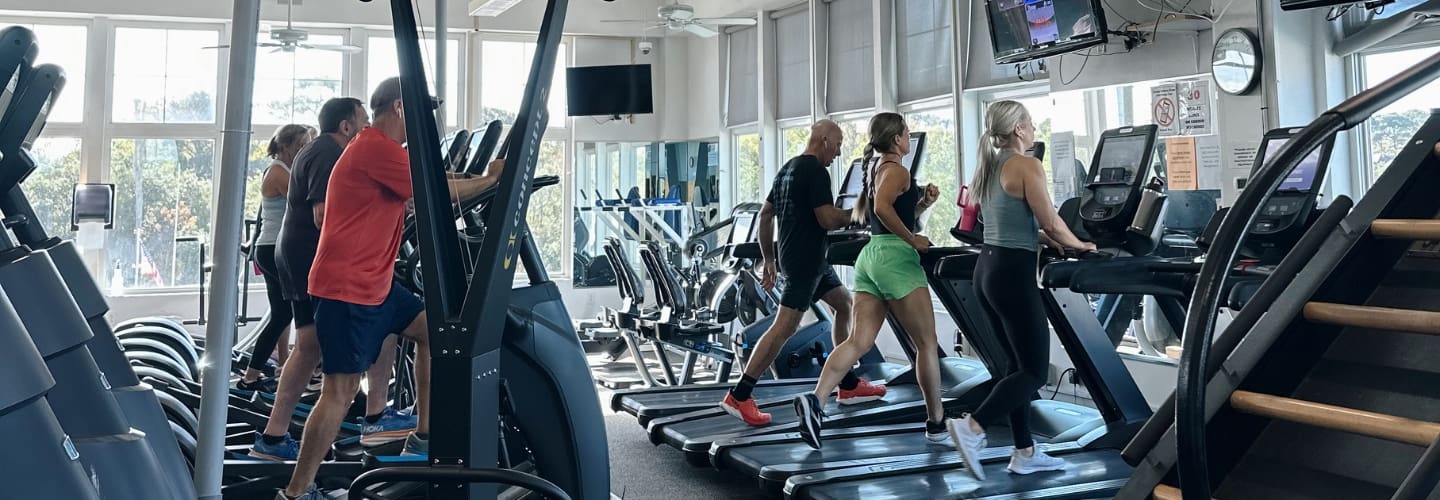 gym members run on treadmills and use elliptical machines on the cardio floor at inlet fitness in virginia beach