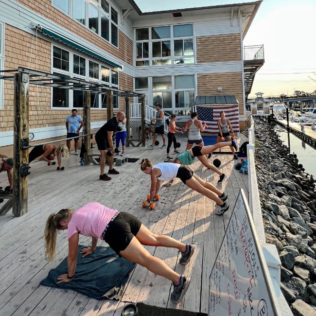 gym members work out on the back deck of inlet fitness in virginia beach