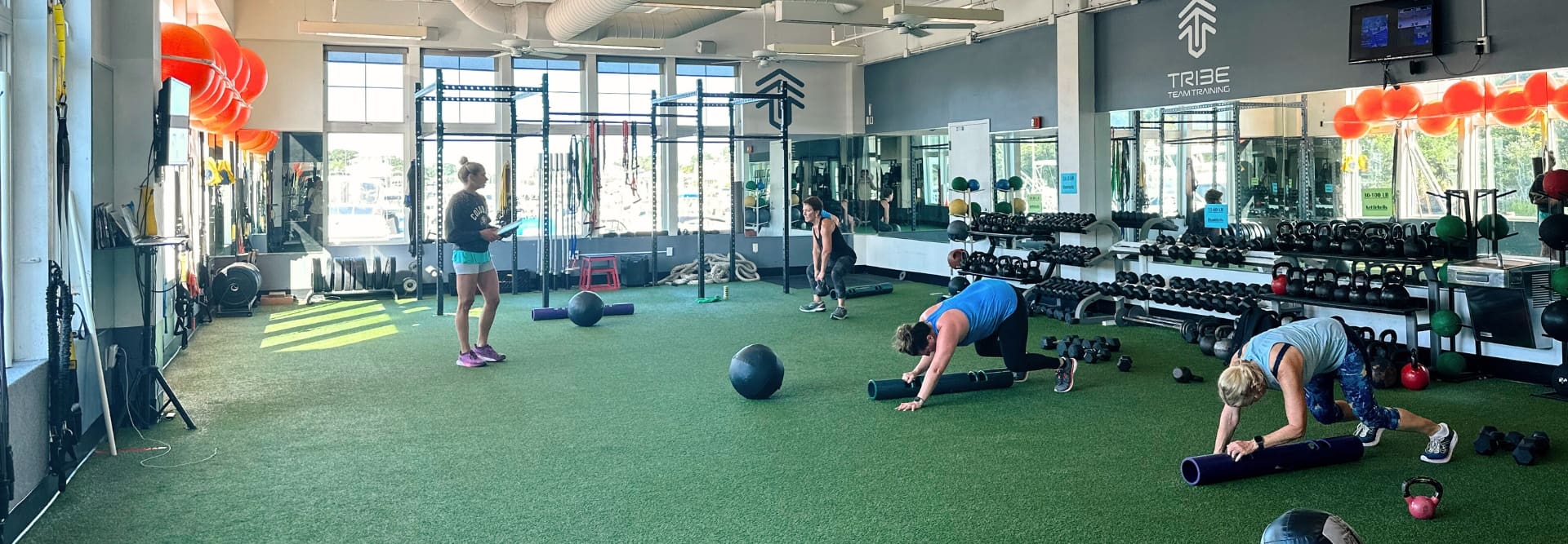 gym members train during a tribe team training small group session at inlet fitness virginia beach